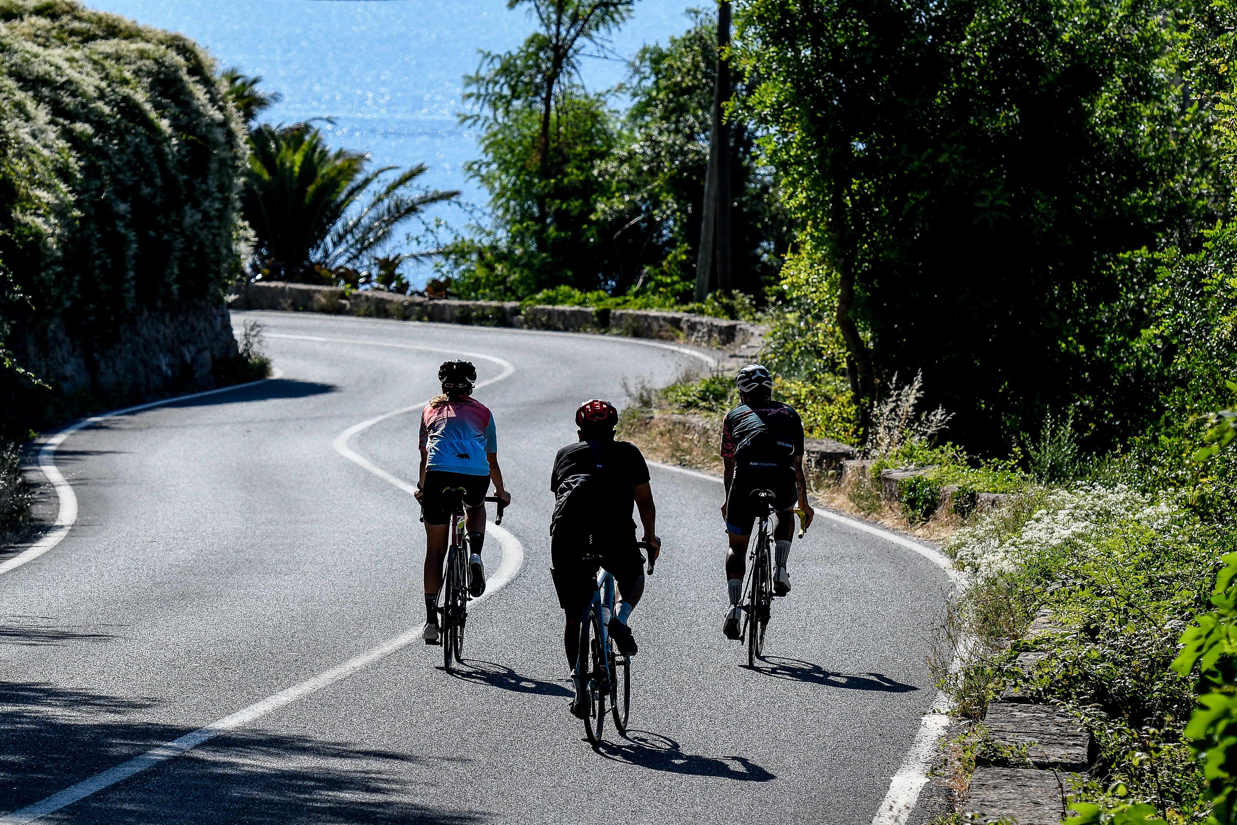 Cyclist climbing Mallorca mountain road — Qunafa premium guided Spain cycling tour