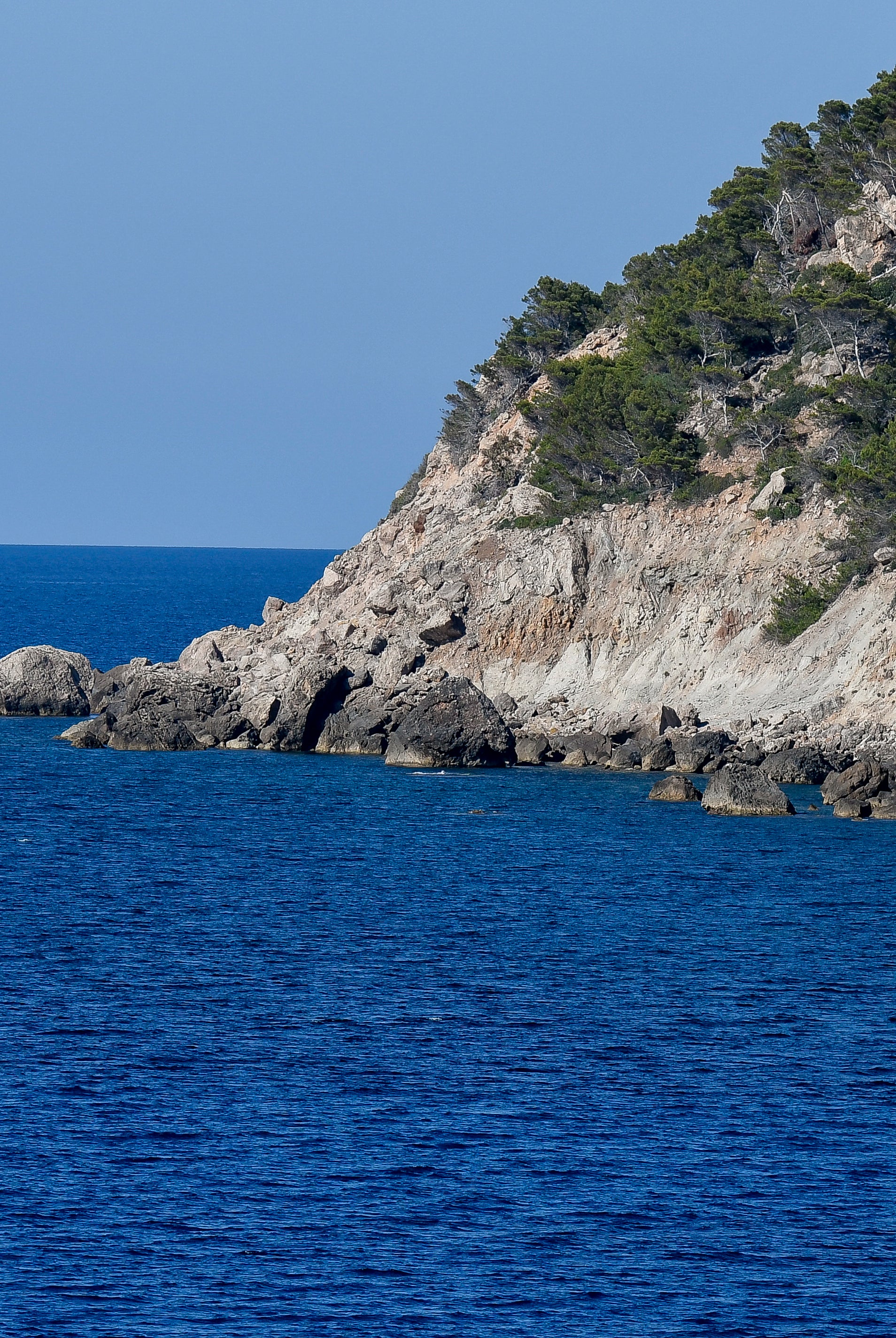 Premium Mallorca cycling tour — cyclist riding coastal road at golden hour Spain