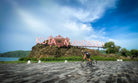 Cyclists riding along Lombok's coastal highway with turquoise water views — Qunafa Travel